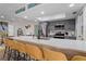 Bright kitchen with gray cabinets, stainless appliances, and a long breakfast bar featuring yellow stools at 11219 93Rd St, Largo, FL 33773