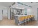 Modern kitchen featuring gray cabinets, stainless steel appliances, and a breakfast bar with yellow stools at 11219 93Rd St, Largo, FL 33773