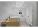 Well-lit laundry room with sink, washer, and dryer at 11219 93Rd St, Largo, FL 33773