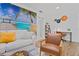 Cozy living room with modern decor, including a beach-themed mural and stylish furniture at 11219 93Rd St, Largo, FL 33773