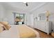 Bright main bedroom with a king bed, slider to pool, and a white dresser with decor at 11219 93Rd St, Largo, FL 33773