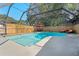 A sparkling in-ground pool is screened in with a seating area, making it perfect for outdoor relaxation at 11219 93Rd St, Largo, FL 33773