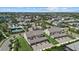 An aerial view of a community with clubhouse and pool with townhomes featuring attached garages at 12029 Cranston Way, Lakewood Ranch, FL 34211