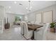 Spacious dining room leading to the living area, complete with modern lighting and neutral decor at 12029 Cranston Way, Lakewood Ranch, FL 34211