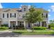 Charming townhouse with symmetrical design, lush greenery, and a well-manicured lawn on a sunny day at 12029 Cranston Way, Lakewood Ranch, FL 34211