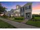 Beautiful townhome showcasing manicured landscaping and a charming, symmetrical facade at dusk at 12029 Cranston Way, Lakewood Ranch, FL 34211