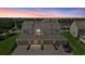 Dusk aerial view features the rear of townhomes with three-car attached garages and a paved driveway at 12029 Cranston Way, Lakewood Ranch, FL 34211