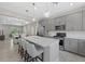Open-concept kitchen with island seating, stainless steel appliances, and seamless flow to the dining and living areas at 12029 Cranston Way, Lakewood Ranch, FL 34211