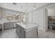 This contemporary kitchen includes an island, stainless steel appliances, and seamless access to outdoor living at 12029 Cranston Way, Lakewood Ranch, FL 34211