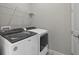 Modern laundry room featuring a Whirlpool washer and dryer set with convenient overhead wire shelving at 12029 Cranston Way, Lakewood Ranch, FL 34211