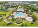 Aerial view of community amenities featuring a pool, playground, basketball court, and surrounding neighborhood at 12592 Ryegrass Loop, Parrish, FL 34219