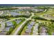 Aerial view of single Gathering homes in a lakeside community with lush greenery at 12592 Ryegrass Loop, Parrish, FL 34219