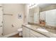 Bathroom featuring double sinks with granite countertops, neutral walls, and modern fixtures at 12592 Ryegrass Loop, Parrish, FL 34219