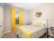 Cozy bedroom with a large window, yellow curtains, and a comfortable bed with flower patterns at 12592 Ryegrass Loop, Parrish, FL 34219