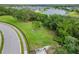 Community dog park with separate fenced areas for small and large dogs, surrounded by green grass and trees at 12592 Ryegrass Loop, Parrish, FL 34219