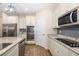 Well-equipped kitchen featuring stainless steel appliances, wooden floors, and ample counter space at 12592 Ryegrass Loop, Parrish, FL 34219