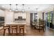 Open concept kitchen and dining area featuring stainless steel appliances, a large island, and sliding glass doors at 12592 Ryegrass Loop, Parrish, FL 34219