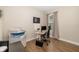 Office space with a desk, computer, printer, wood flooring, and natural lighting at 12592 Ryegrass Loop, Parrish, FL 34219