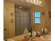 Bright bathroom featuring double sinks, ample counter space, and a decorative shower curtain at 12809 7Th Ne Ave, Bradenton, FL 34212