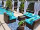 Relaxing pool deck featuring cozy outdoor furniture, elegant curtains, and a stylish rug at 12809 7Th Ne Ave, Bradenton, FL 34212