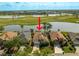 This aerial view showcases a home near a golf course and lake, equipped with solar panels at 1322 Millbrook Cir, Bradenton, FL 34212