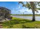 Screened in patio overlooks a serene lake and lush green golf course under a sunny, blue sky at 1322 Millbrook Cir, Bradenton, FL 34212