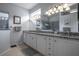 Bathroom featuring a double vanity with granite countertop, ample lighting, and a walk-in shower at 1322 Millbrook Cir, Bradenton, FL 34212