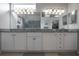 Bathroom with a double vanity, granite countertop, and a large mirror reflecting the shower at 1322 Millbrook Cir, Bradenton, FL 34212