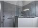 Contemporary bathroom featuring a glass shower with gray tile and a convenient safety bar for accessibility at 1322 Millbrook Cir, Bradenton, FL 34212