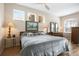 Serene bedroom with plenty of light, features a ceiling fan, warm paint, and two side tables at 1322 Millbrook Cir, Bradenton, FL 34212