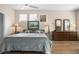 Calm bedroom boasts wood floors, natural light from windows, and ample space for relaxation at 1322 Millbrook Cir, Bradenton, FL 34212