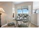 Sunny breakfast nook with a glass table and white chairs, sliding doors to a screened patio at 1322 Millbrook Cir, Bradenton, FL 34212
