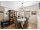 Elegant dining room featuring a chandelier and a wooden china cabinet with glass doors at 1322 Millbrook Cir, Bradenton, FL 34212