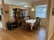 Bright dining area featuring wood floors, large windows with blinds, and a classic wood china cabinet at 1322 Millbrook Cir, Bradenton, FL 34212