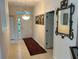 Inviting entryway with a light-filled foyer, decorative rug, and a stylish ornate mirror adds a touch of elegance at 1322 Millbrook Cir, Bradenton, FL 34212