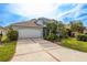 Well-maintained two-story home with a wide driveway and lush landscaping at 1322 Millbrook Cir, Bradenton, FL 34212