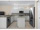 Well-lit kitchen with white cabinets, stainless steel appliances, and granite countertops at 1322 Millbrook Cir, Bradenton, FL 34212