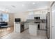 Bright kitchen features white cabinets, stainless steel appliances, and island with granite countertops at 1322 Millbrook Cir, Bradenton, FL 34212
