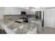 Bright kitchen with white cabinets, stainless steel appliances and granite countertops adds a touch of elegance at 1322 Millbrook Cir, Bradenton, FL 34212