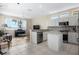 Open concept kitchen featuring white cabinets, stainless steel appliances, and connection to the living area at 1322 Millbrook Cir, Bradenton, FL 34212