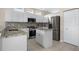 Updated kitchen featuring white cabinets, stainless steel appliances, and stylish granite countertops at 1322 Millbrook Cir, Bradenton, FL 34212