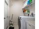 Functional laundry room with modern washer and dryer and storage shelves at 1322 Millbrook Cir, Bradenton, FL 34212