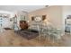 Bright living area showcases a glass top dining table, comfortable seating, and hardwood floors at 1322 Millbrook Cir, Bradenton, FL 34212