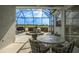 Relaxing screened-in patio featuring a built-in hot tub with a view of the lake at 1322 Millbrook Cir, Bradenton, FL 34212