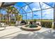 Enclosed patio featuring a built-in hot tub with views of the lake and golf course at 1322 Millbrook Cir, Bradenton, FL 34212