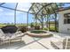 Screened-in patio featuring a hot tub with views of the water at 1322 Millbrook Cir, Bradenton, FL 34212
