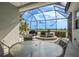 Screened patio featuring a hot tub and an outdoor dining area overlooking the scenic lake at 1322 Millbrook Cir, Bradenton, FL 34212