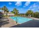 Community pool with several chairs for residents and clear blue skies at 1322 Millbrook Cir, Bradenton, FL 34212