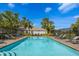 Inviting community pool lined with lounge chairs and tropical landscaping, perfect for relaxation at 1322 Millbrook Cir, Bradenton, FL 34212