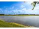 Tranquil water view highlighting the lush green grassy bank contrasting with the serene water at 1322 Millbrook Cir, Bradenton, FL 34212
